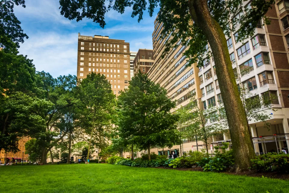 Rittenhouse Square, a park in Philadelphia, framed by large buildings.